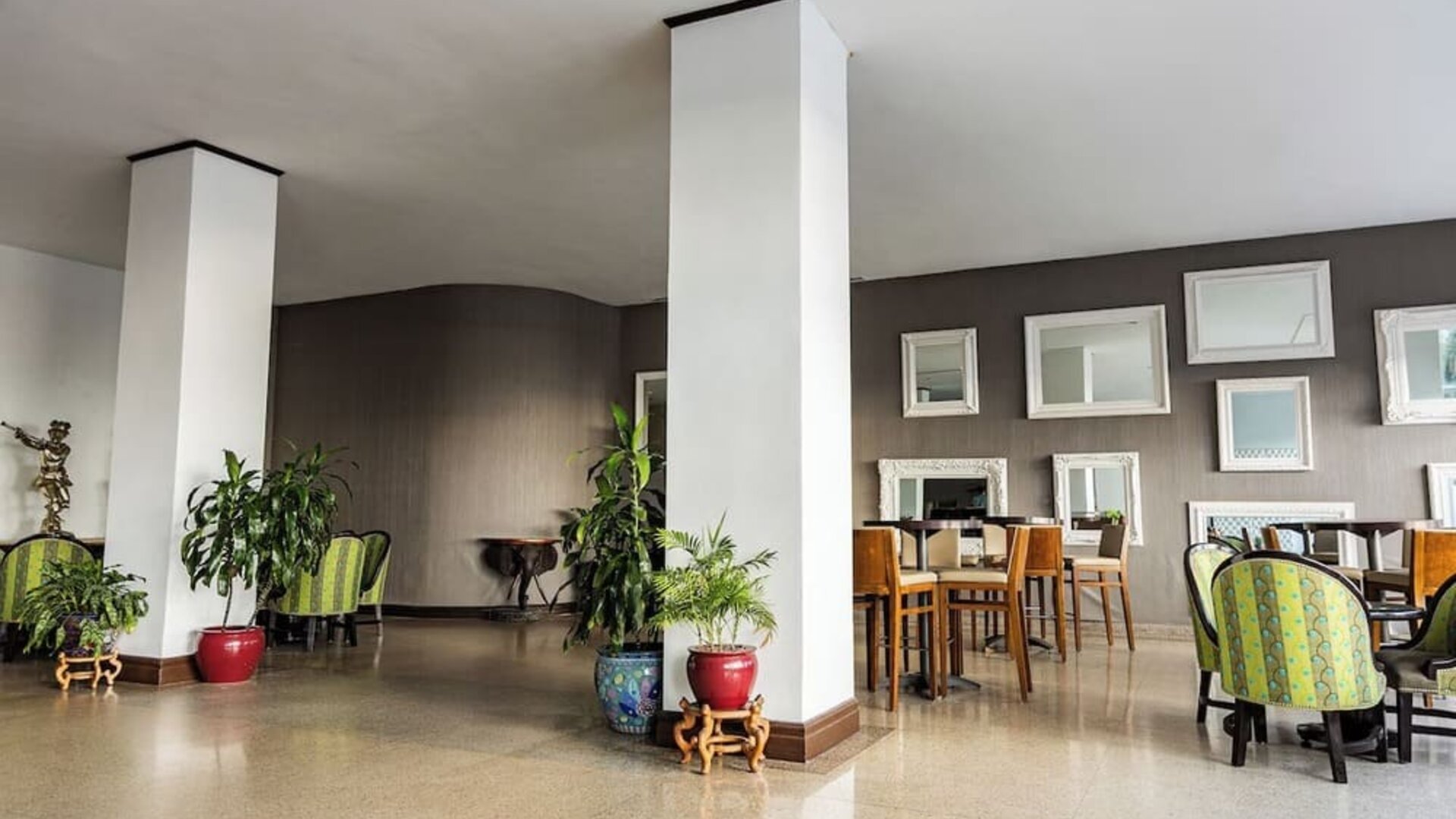 Hotel lounge area with seating and decorative mirrors at Sherry Frontenac Oceanfront Hotel.