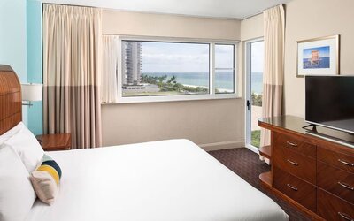 Guest room with a king bed and ocean view at Sherry Frontenac Oceanfront Hotel.