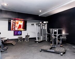 Fitness center with strength training equipment and free weights at Sherry Frontenac Oceanfront Hotel.