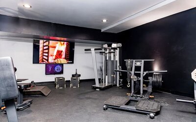 Fitness center with strength training equipment and free weights at Sherry Frontenac Oceanfront Hotel.