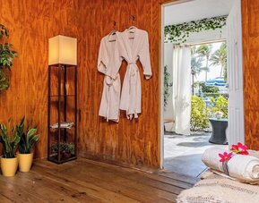 Spa relaxation area with robes and seating at Sherry Frontenac Oceanfront Hotel.