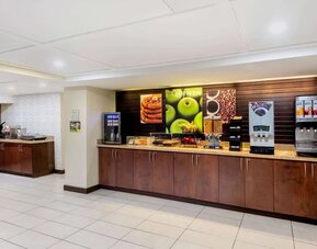 Breakfast area with self-serve coffee, juice, and buffet stations at La Quinta Inn & Suites By Wyndham Oshawa.