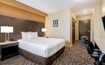 Guest room with a king bed and work desk at La Quinta Inn & Suites By Wyndham Oshawa.