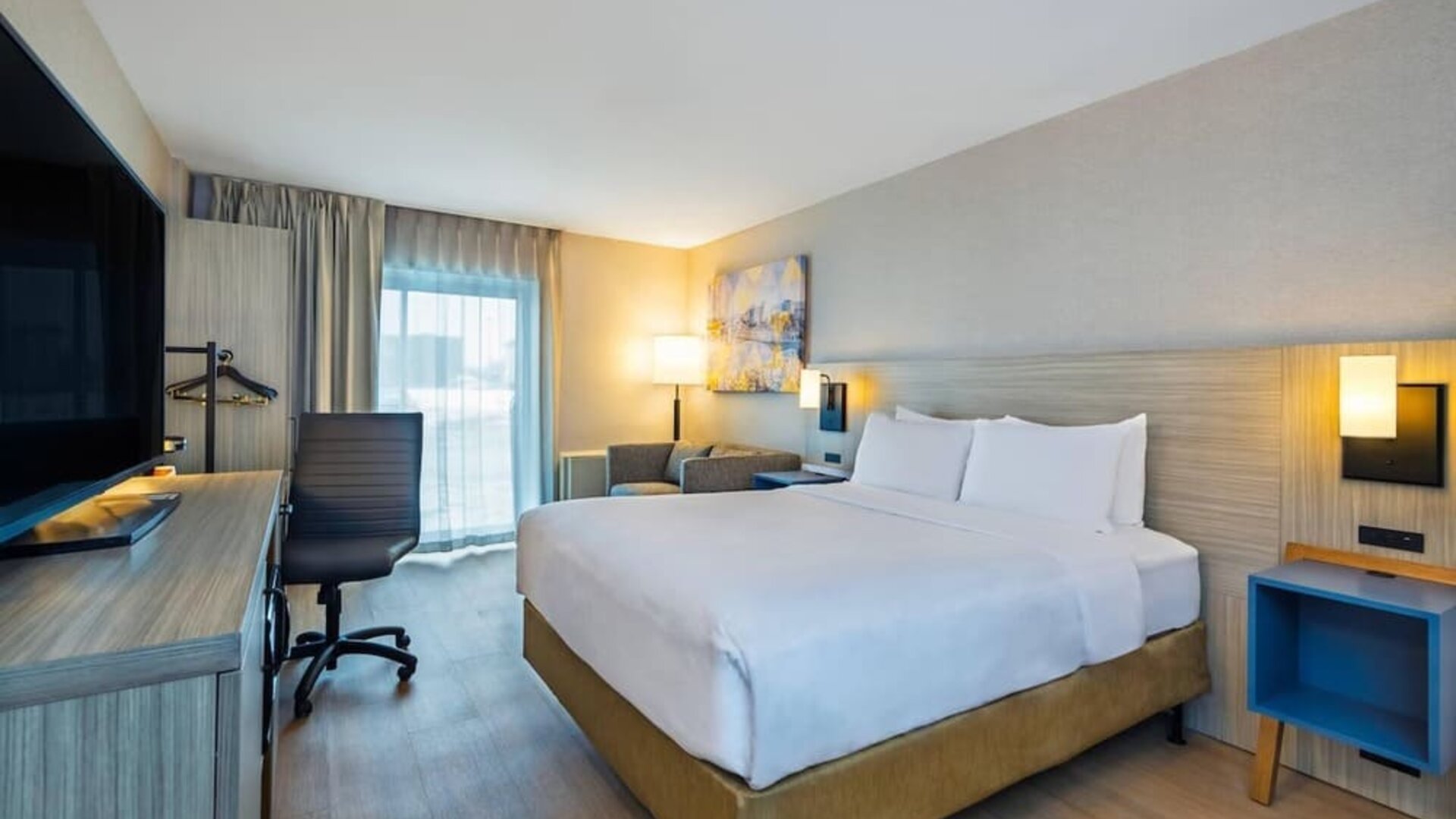 Guest room with a king bed and seating area at Comfort Inn Saskatoon.