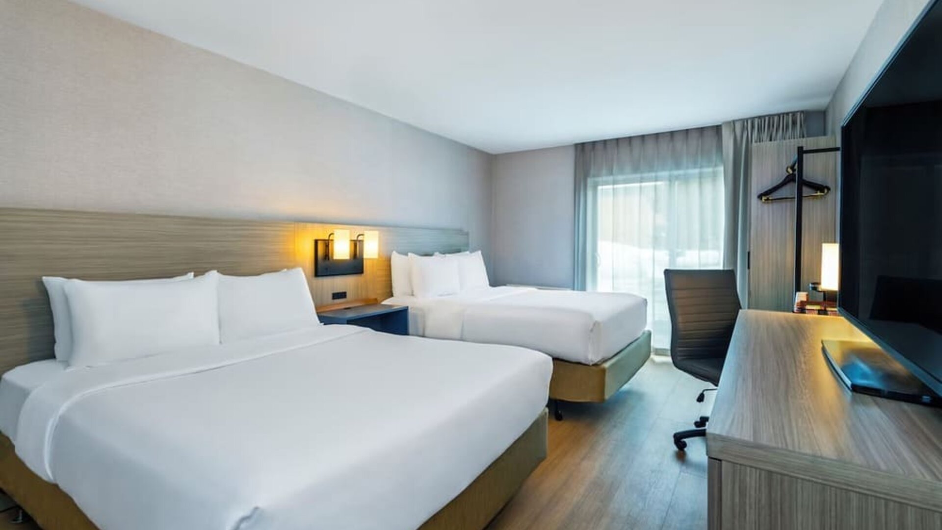 Guest room with two queen beds and a work desk at Comfort Inn Saskatoon.