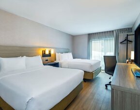 Guest room with two queen beds and a work desk at Comfort Inn Saskatoon.