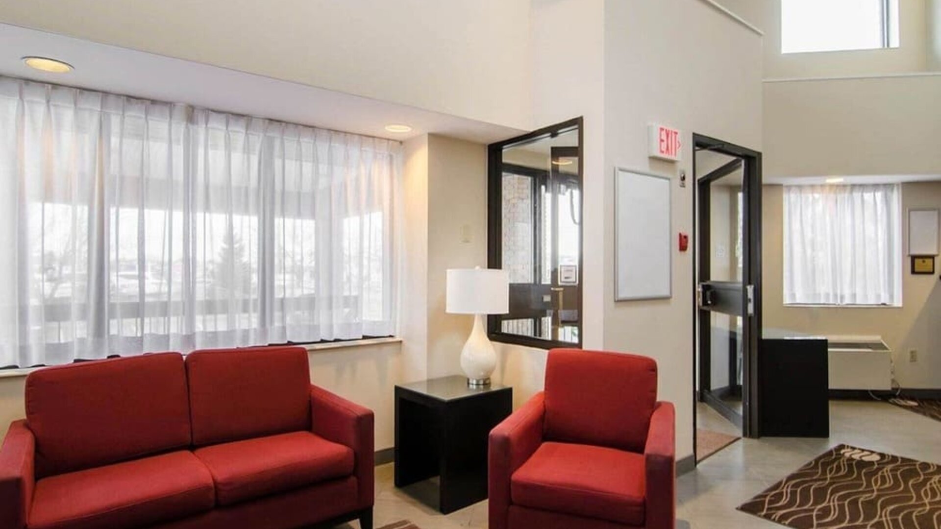 Hotel lobby seating area with large windows at Comfort Inn Saskatoon.