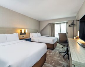 Guest room with two queen beds and a work desk at Comfort Inn Saskatoon.