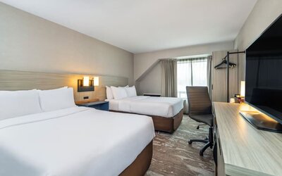 Guest room with two queen beds and a work desk at Comfort Inn Saskatoon.