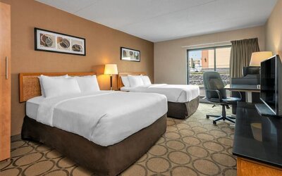 Guest room with two queen beds and a work desk at Comfort Inn Prince Albert.