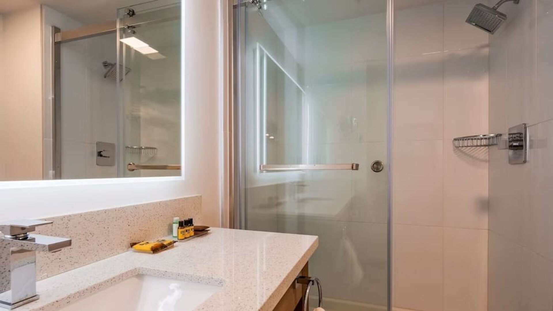Day use guest bathroom with shower and toiletries at Executive Residency By Best Western.