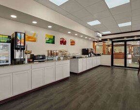 Breakfast buffet with beverage station, cereal dispensers and countertop dining service area at Quality Inn Yemassee - Point South I-95.