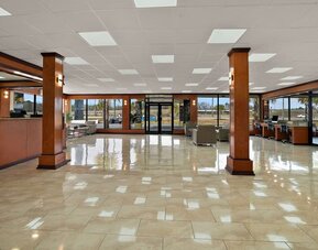 Spacious hotel lobby with polished tile floors, seating areas and large glass entrance doors at Quality Inn Yemassee - Point South I-95.