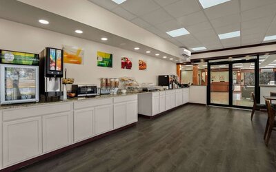 Breakfast buffet with beverage station, cereal dispensers and self-service countertop area at Econo Lodge Yemassee.