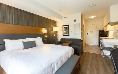 Day use king suite with work desk, private bathroom and in-room kitchen at Executive Residency By Best Western.