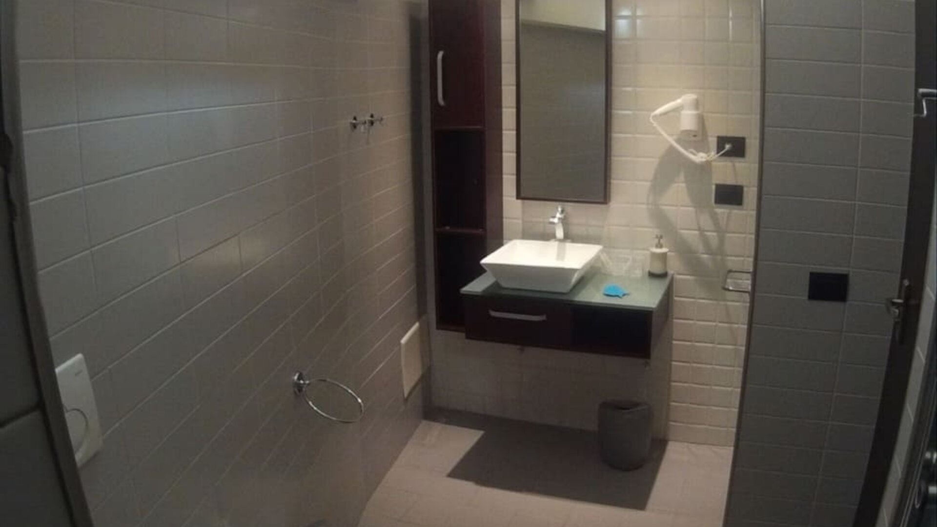 Modern bathroom with glass-enclosed shower, bidet and contemporary vanity at Dolce Vita Rooms & Breakfast.