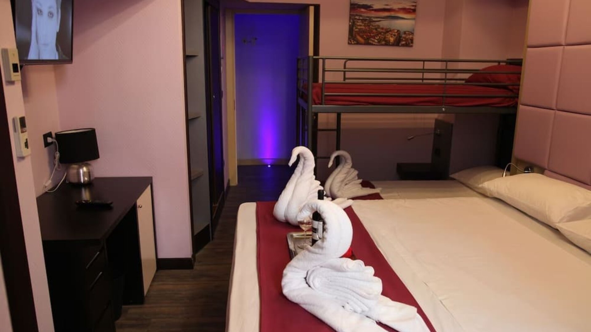 Family room with one double bed, bunk beds and complimentary wine at Dolce Vita Rooms & Breakfast.