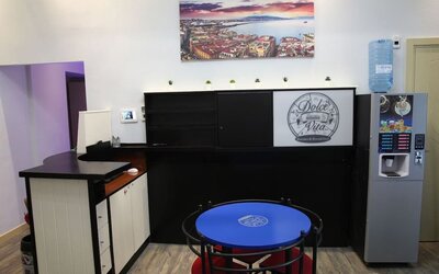 Bright breakfast area with café seating and self-service beverage station at Dolce Vita Rooms & Breakfast.