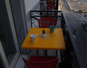 Private balcony with table, seating and views of the surrounding city at Dolce Vita Rooms & Breakfast.
