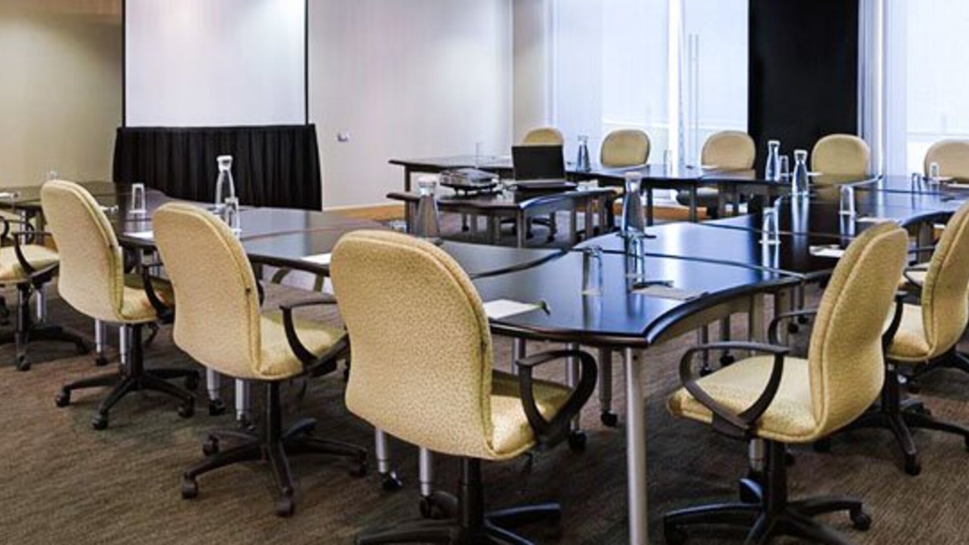 Fully equipped meeting room with conference tables, ergonomic seating and presentation space at NH Collection Mexico City Airport T2.