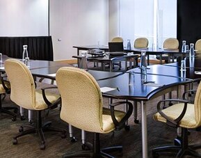 Fully equipped meeting room with conference tables, ergonomic seating and presentation space at NH Collection Mexico City Airport T2.