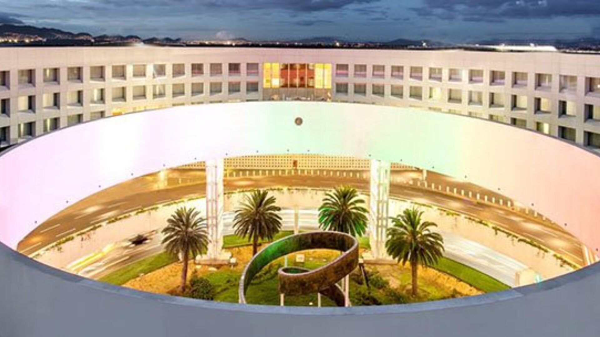 Aerial exterior view of NH Collection Mexico City Airport T2 showcasing the hotel's distinctive circular architecture and landscaped central courtyard.