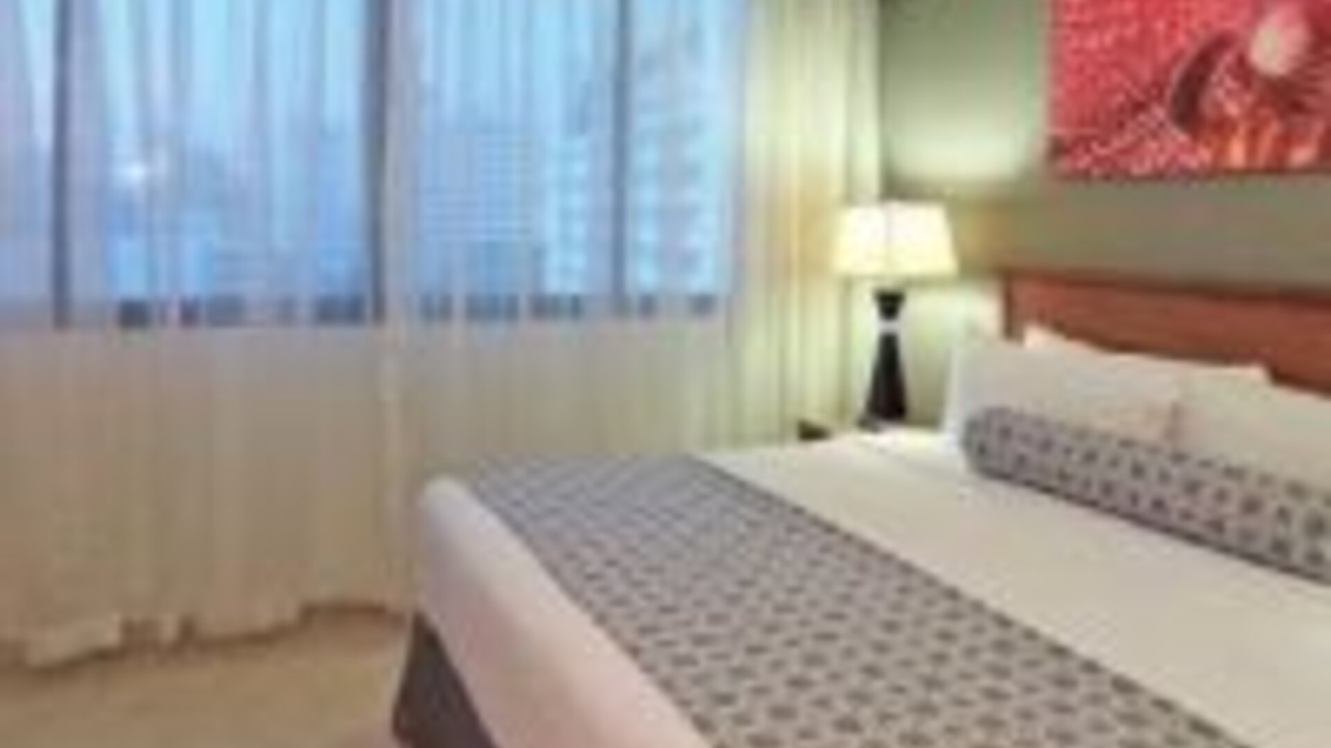 Bright guest room with king bed, large window and contemporary furnishings at Crowne Plaza Panama.