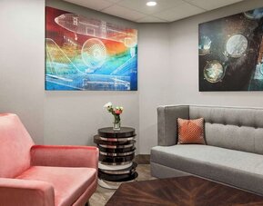 Comfortable hotel lounge with modern seating, contemporary artwork and a welcoming space to relax at Hampton Inn Chicago O'Hare.