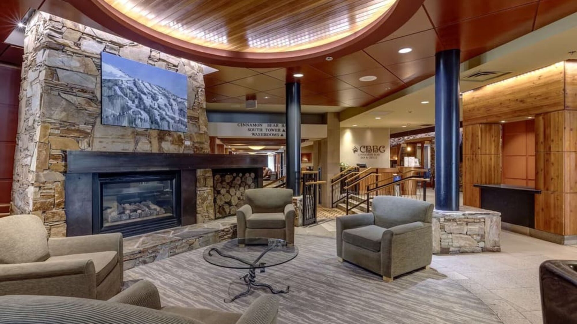 Hotel lobby with lounge area and fire place at Hilton Whistler Resort & Spa.