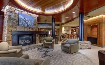 Hotel lobby with lounge area and fire place at Hilton Whistler Resort & Spa.