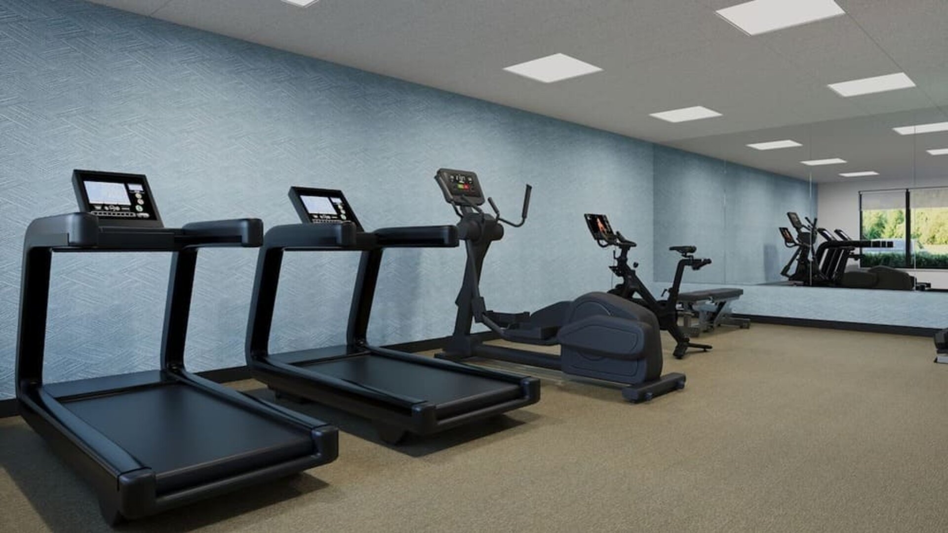 Fitness center equipped with treadmills, elliptical machine, exercise bike and strength training equipment at Hyatt Select Philadelphia Airport.
