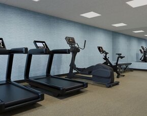 Fitness center equipped with treadmills, elliptical machine, exercise bike and strength training equipment at Hyatt Select Philadelphia Airport.