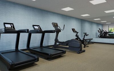 Fitness center equipped with treadmills, elliptical machine, exercise bike and strength training equipment at Hyatt Select Philadelphia Airport.