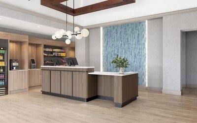 Hotel reception area featuring a modern front desk, snack market and welcoming lobby at Hyatt Select Philadelphia Airport.