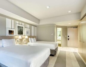 Bright guest room featuring two queen beds, contemporary décor and a spacious layout at Royal Sonesta Minneapolis.