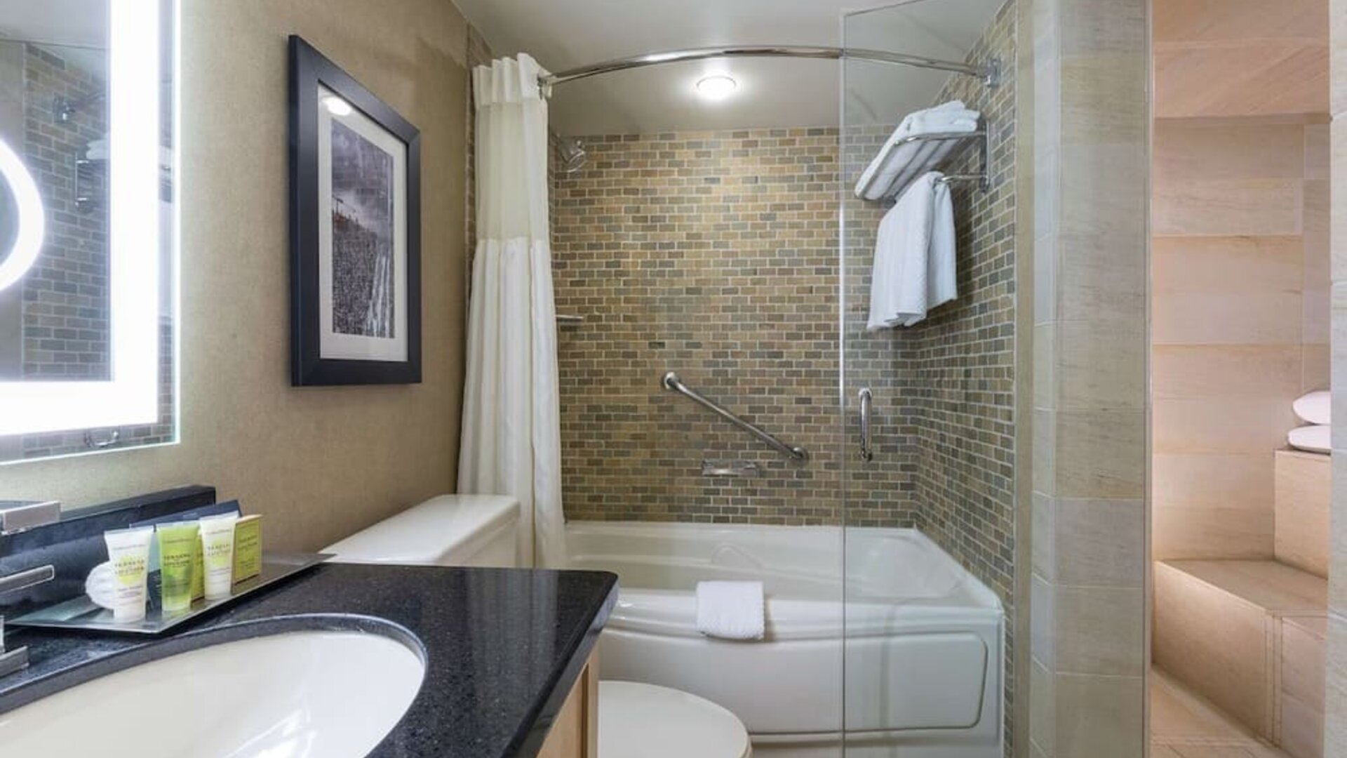 Guest bathroom with tub, sauna and toiletries at Hilton Whistler Resort & Spa.