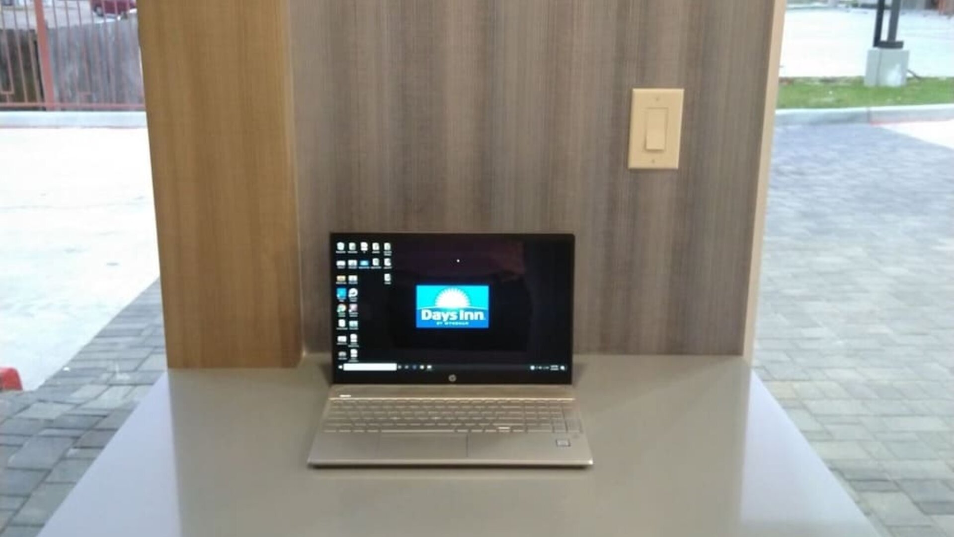 Business center at Days Inn & Suites By Wyndham Downtown/University Of Houston featuring a laptop workstation beside large windows.