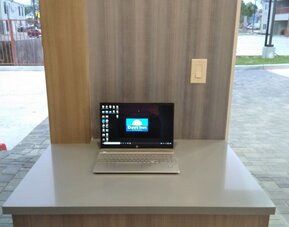 Business center at Days Inn & Suites By Wyndham Downtown/University Of Houston featuring a laptop workstation beside large windows.