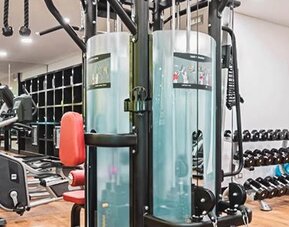 Fitness center at NH Collection Mexico City Centro Histórico featuring cardio machines, strength-training equipment and free weights.
