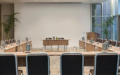 Meeting facility at Holiday Inn Lima Airport featuring U-shaped conference tables, ample seating and presentation space.
