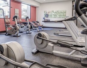 Fitness center at Courtyard Panama Metromall featuring treadmills, stationary bikes, weight equipment and large windows