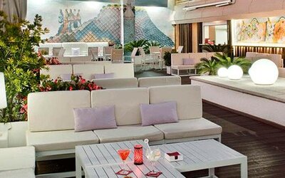 Stylish outdoor terrace featuring lounge seating, greenery and decorative lighting at NH Collection Barcelona Pódium.
