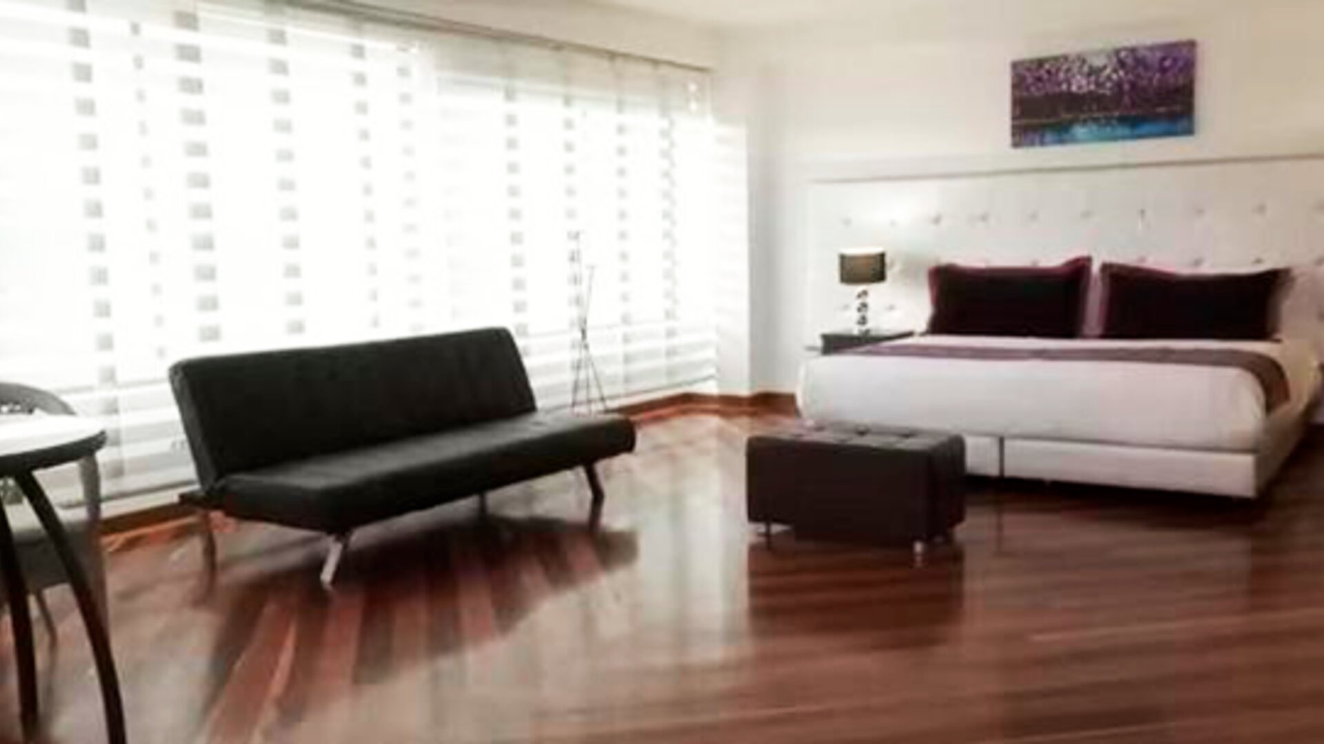 Bright guest room featuring a king bed, large window, city views and contemporary furnishings at Hotel Airport Travel.