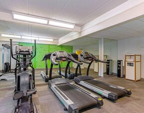 Fitness center featuring treadmills, an elliptical machine and cardio equipment for convenient workouts at La Quinta Inn & Suites By Wyndham Orlando I Drive/Conv Ctr.