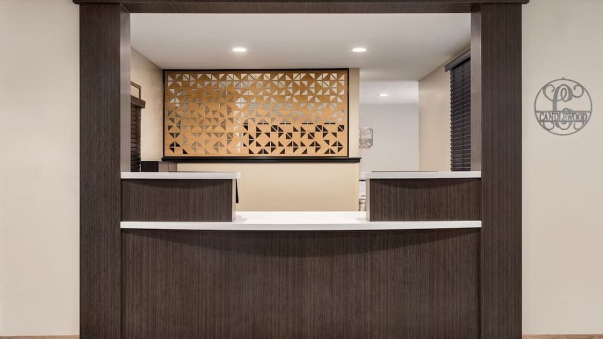 Reception desk featuring contemporary design, warm wood finishes and convenient guest services at Candlewood Suites Meridian.