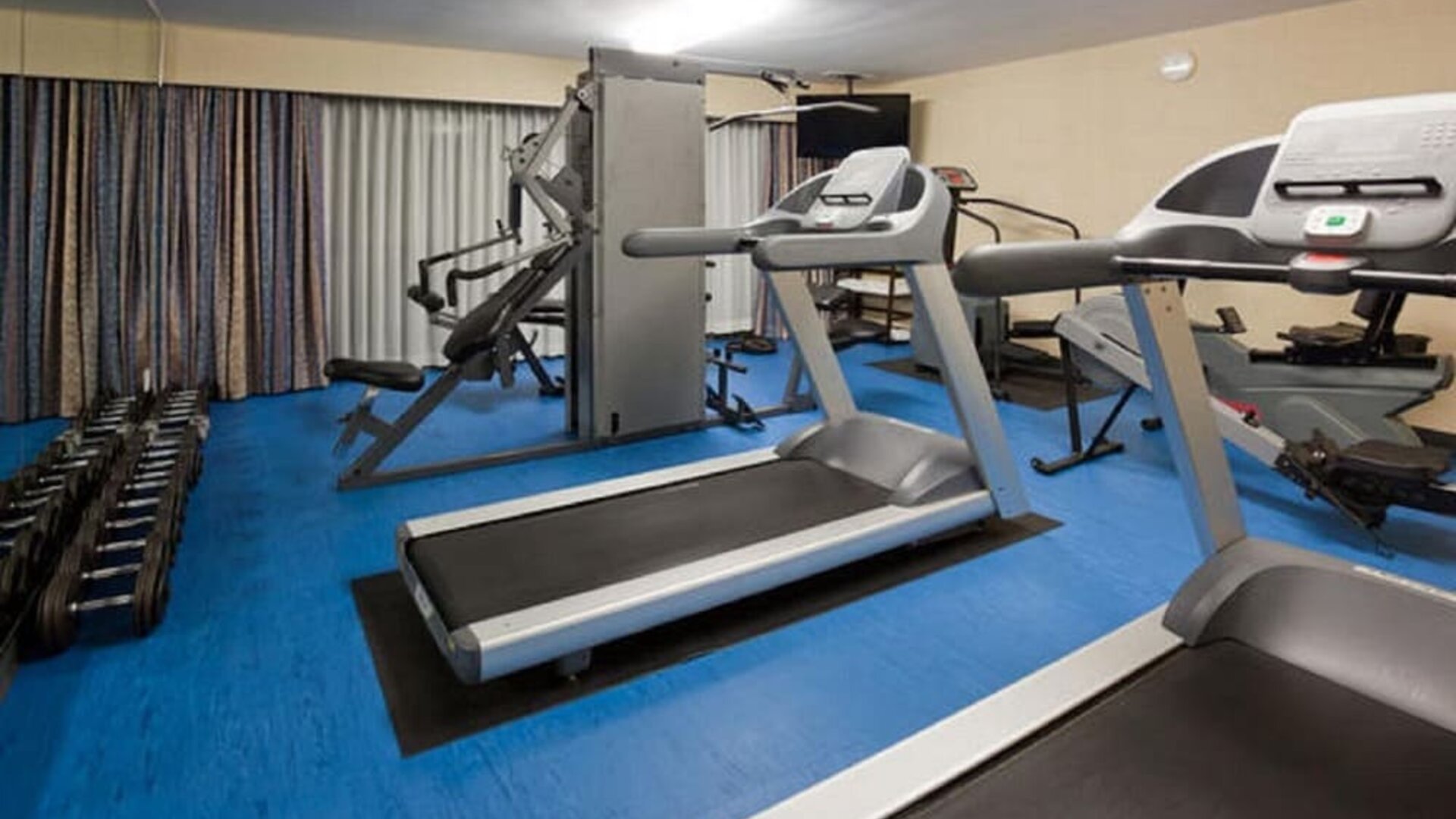 Fitness center featuring treadmills, strength-training equipment and free weights for a complete workout experience at Holiday Inn Toronto Airport East.