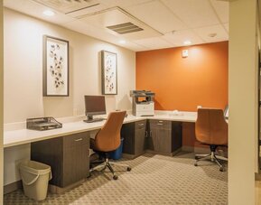 Business center featuring computer workstations, printing services and a dedicated workspace for productivity at Candlewood Suites Boise.