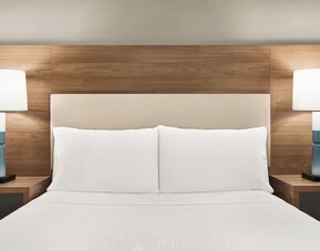 Guest room featuring a plush king-size bed, contemporary furnishings and bedside lighting for a comfortable stay at Candlewood Suites Boise.