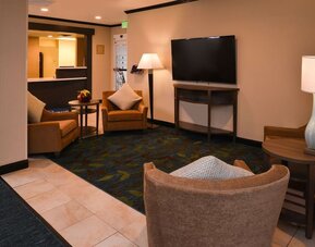 Lobby lounge featuring comfortable seating, warm wood accents and a relaxed gathering space at Candlewood Suites Boise.