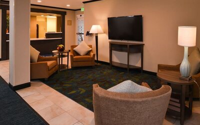 Lobby lounge featuring comfortable seating, warm wood accents and a relaxed gathering space at Candlewood Suites Boise.